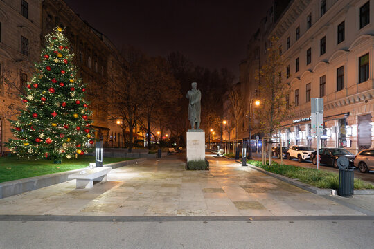 Liszt Ferenc square at night and the statue of the journalist and poet Endre Ady in Budapest, Hungary