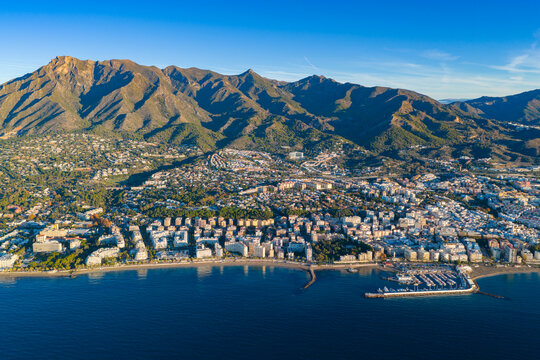 Luxury Living at Dawn: Cinematic 4K Aerial of Marbella&rsquo;s Golden Mile, Featuring Exclusive Beachfront Resorts, the Paseo Mar&iacute;timo, and La Concha Mountain, Costa del Sol, Spain