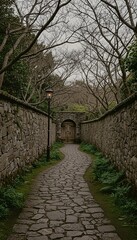 Fototapeta premium Winding cobblestone path leads to an ancient wooden door, flanked by weathered stone walls and illuminated by a glowing street lamp under a cloudy sky.