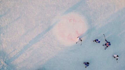 Aerial view of ice hockey players during match play. Concept of sports analytics visuals, broadcast overview shots, tactical analysis content, league media production, event documentation.