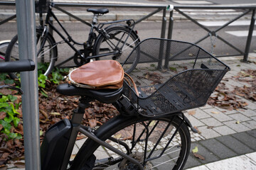 leather bag with kiss lock clasp on a black bicycle seat