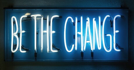 Fototapeta premium Bright neon sign displays inspirational message. Blue light illuminates dark wall, creating dramatic effect. Simple, bold typography.