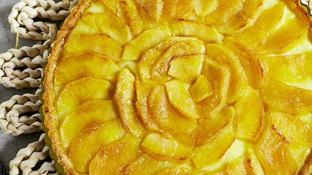 Apple Tart Pie Centered on Rustic Plaited Doily with Fresh Apple Slices and Cutlery
