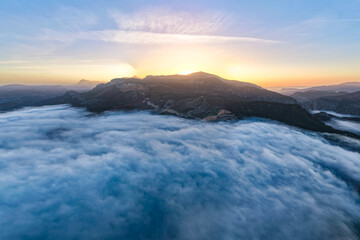 Aerial Sunrise Above the Clouds at Caminito del Rey, Guadalhorce Lake, and the Pine Forests of Andalusia, Spain