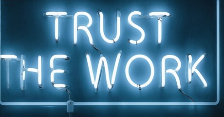 Fototapeta premium Bright neon sign displays motivational phrase. Blue glow contrasts dark background. Simple message inspires confidence, dedication.