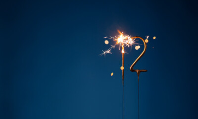 12 years celebration festive background with copy space made with Bengal fires in the form of number Twelve.