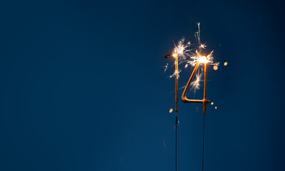 14 years celebration festive background with copy space made with Bengal fires in the form of number Fourteen.