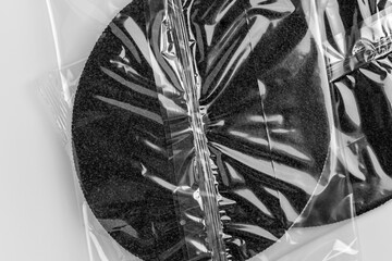 Filtration cartridge in clear protective wrap. Water treatment equipment on white table