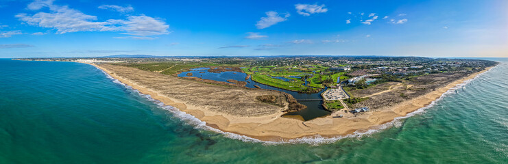 The Ultimate Retirement Dream: Cinematic Aerial Flyover of Salgados Golf Course Nestled Between the Atlantic Ocean and Natural Lagoons in Algarve, Portugal