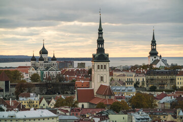 View of spires and domes rise above a tapestry of red-tiled roofs, a medieval skyline against a backdrop of the Baltic Sea, Tallinn, Harju County, Estonia.