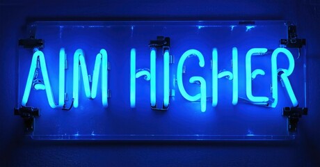 Fototapeta premium Bright blue neon sign displays text AIM HIGHER. Background is dark gray wall. Simple, motivational message.