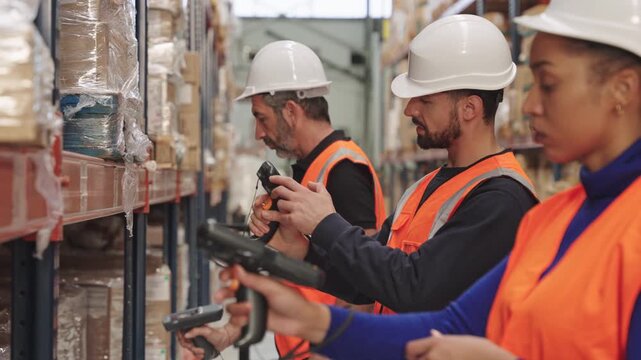 Warehouse workers scanning barcodes on shelves