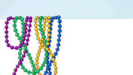 Colorful carnival bead strands arranged on a white surface  