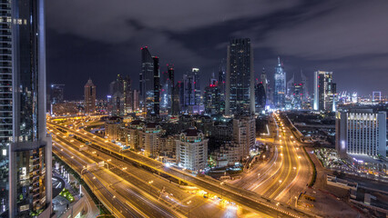 Aerial view on downtown and financial district in Dubai during all night timelapse, United Arab Emirates with skyscrapers and highways.
