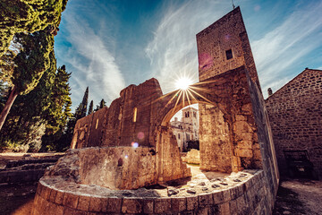 View of sunlight bursting through the ancient stone ruins, casting long shadows across the weathered ground, evoking a sense of history, Dubrovnik, Dubrovnik-Neretva County, Croatia.