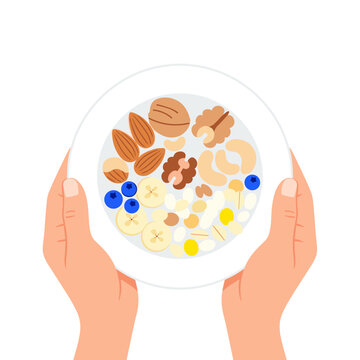 Hands holding a plate of muesli with nuts and berries  