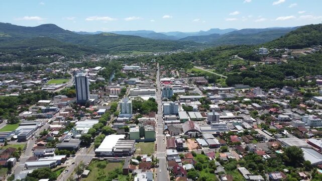 Cinematic high angle drone view of Igrejinha city in the South of Brazil. Urban development with green mountains in the background. High bitrate master in ProRes 422.