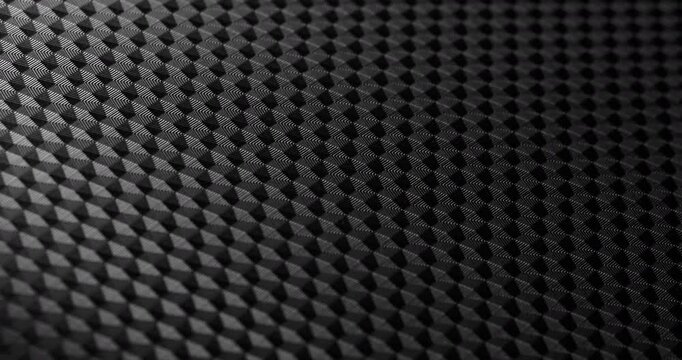 Carbon Texture Seamless Loop. Close-up of premium black carbon fiber weave with subtle light shift, creating a high-tech, endlessly background.