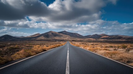 Road leading to mountains under a dramatic sky landscape scenic view