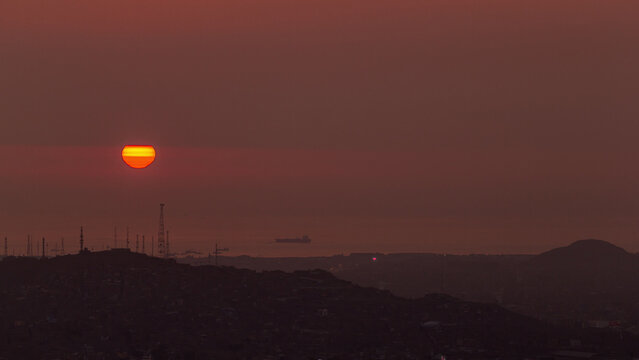 Aerial view of the Pacific ocean during sunset timelapse from Cerro San Cristobal, Lima - Powered by Adobe
