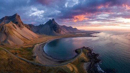 Coastal mountains and ocean landscape during sunset with colorful sky panorama