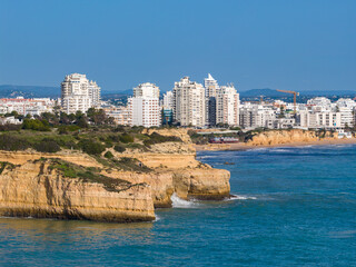 Algarve Luxury Real Estate: Panoramic 4K Aerial View of Premium Villas and Resorts in Arma&ccedil;&atilde;o de P&ecirc;ra Overlooking the Turquoise Coastline of Praia de Albandeira, Portugal