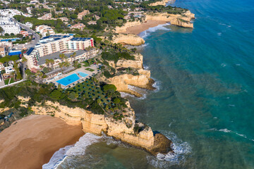 The Golden Coast: Aerial Cinematic 4K View of Luxury Villas, Resorts, and Real Estate at Alporchinhos Overlooking the Turquoise Waters of Praia de Albandeira, Algarve, Portugal