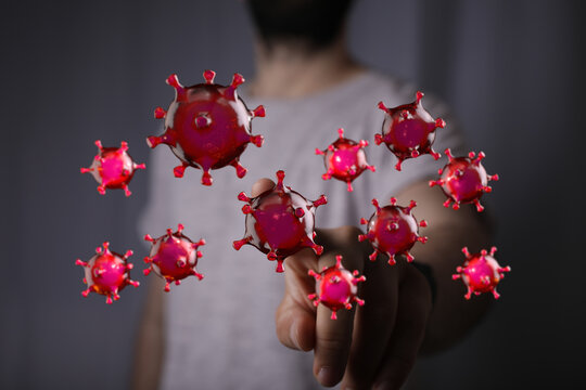 Conceptual image of hand interacting with digital virus illustration, symbolizing contact, infection, and prev