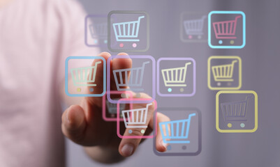 A person's finger pointing at a variety of shopping cart icons, symbolizing online shopping and e-commerce. Great for illustrating the ease of d