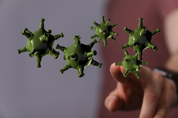 Visual representation of a virus or disease with a hand approaching the microorganisms, highlighting the conce
