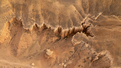 Rugged desert landscape with rocky formations and sparse vegetation © Михаил Уванов
