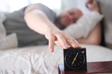 Hand Reaching for the Alarm Clock