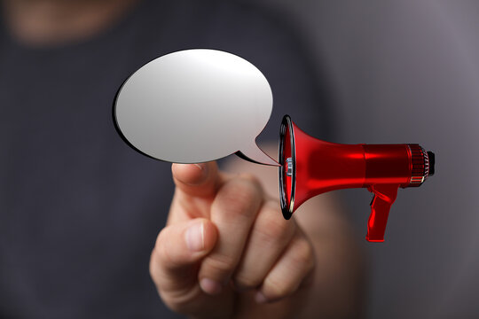 A person uses a digital loudspeaker to display a speech bubble, concept about communication, announcements and sharing ideas. Symbolizing inform