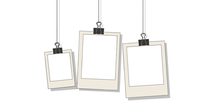 Set of blank polaroid style photo frames hanging on strings with black clips against a plain white background for collage.