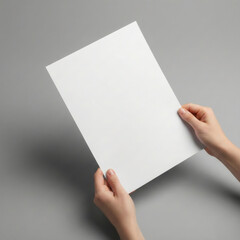 Blank paper mockup held by hands on gray background