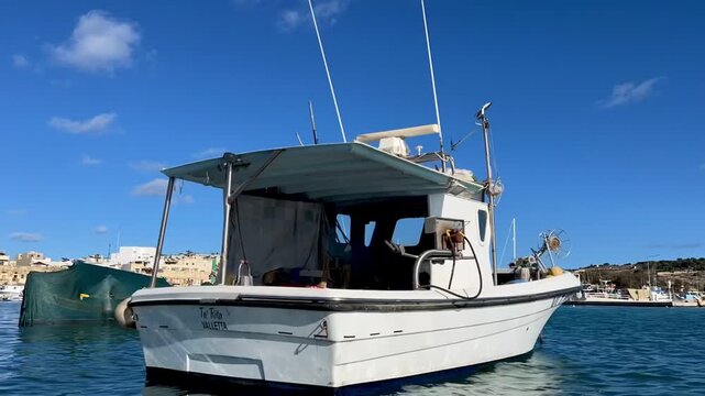 Traditional maltese fishing boats floating in marsaxlokk harbor