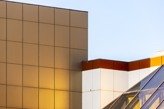 View of the reflective gold and white facade of a modern building contrasting against the clear blue sky in Aktau, Mangystau Region, Kazakhstan.