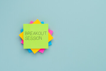 A stack of colorful sticky notes with text BREAKOUT SESSION. Meetings, conferences, workshops, brainstorming concept.