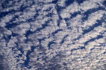 Beautiful cloudy sky with small fluffy white clouds.