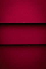 Red paper background with three horizontal strips creating a vibrant and bold design in a simple layout
