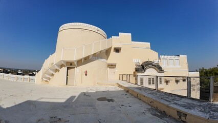 Exterior Architectural Detail of a Rajputana Fort Terrace Featuring a Cylindrical Staircase Tower and Heritage Design in Rajasthan, India 