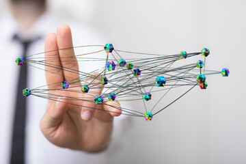 Concept of connection, global network and communication. Man hand touching a digital web of connections.