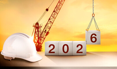 A construction crane is lifting and placing the number 6 in a cube to celebrate the start of the new year 2026 in the construction industry.