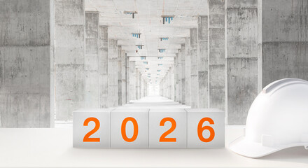 Happy New Year 2026 Real Estate and Construction Industry. White Helmet and a numbered concrete cube on the desk of an engineer or construction worker. welcome new year party and change  new business