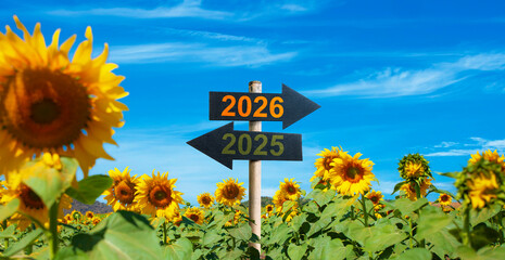 2026 to the right and 2025 to the left. road signs in the sunflower garden. start to be Successful in the new year.