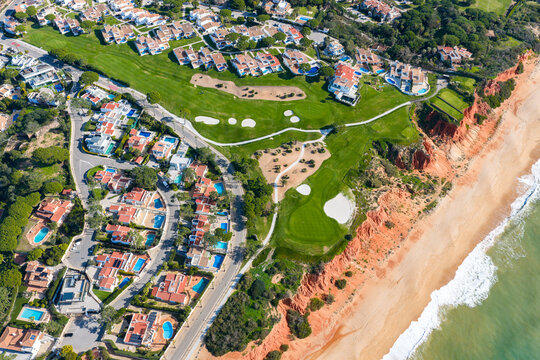 Luxury Living in the Golden Triangle: Cinematic 4K Aerial of Vale do Lobo Royal Golf Course and the Iconic Crimson Cliffs of Praia do Trafal, Algarve, Portugal