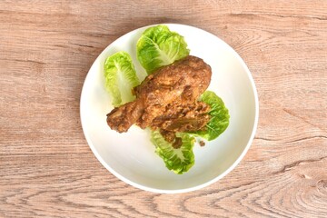 fried chicken leg herb curry and baby cos lecctue on plate