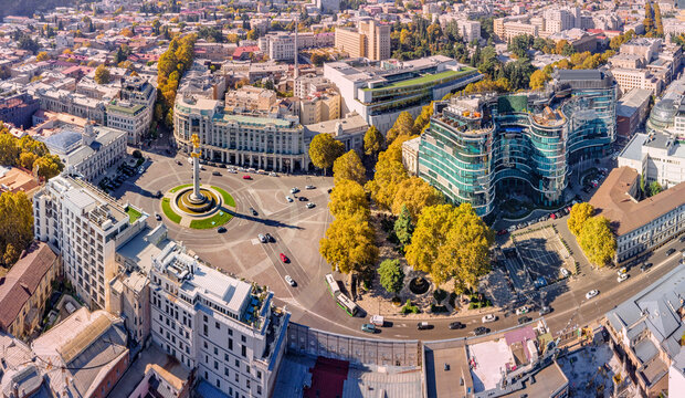 1 November 2025, Tbilisi, Georgia: Aerial view of the Freedom Monument, a central roundabout, with vehicles moving through the city during autumn