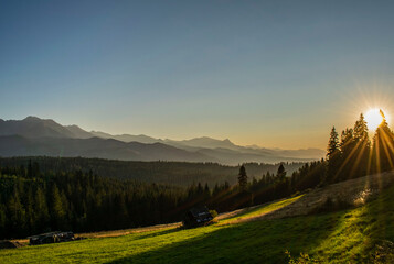 sunset on a green glade with the Tatra Mountains in the background