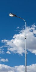 Illuminated Lamp-Post Against a Clear Blue Sky: A Vibrant View of Street Lighting in Urban Settings